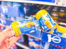 hand holding a tube of pillsbury grands biscuits in walmart aisle