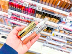 hand holding cosmetics in walgreens