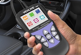 a hand holding a check engine light tool