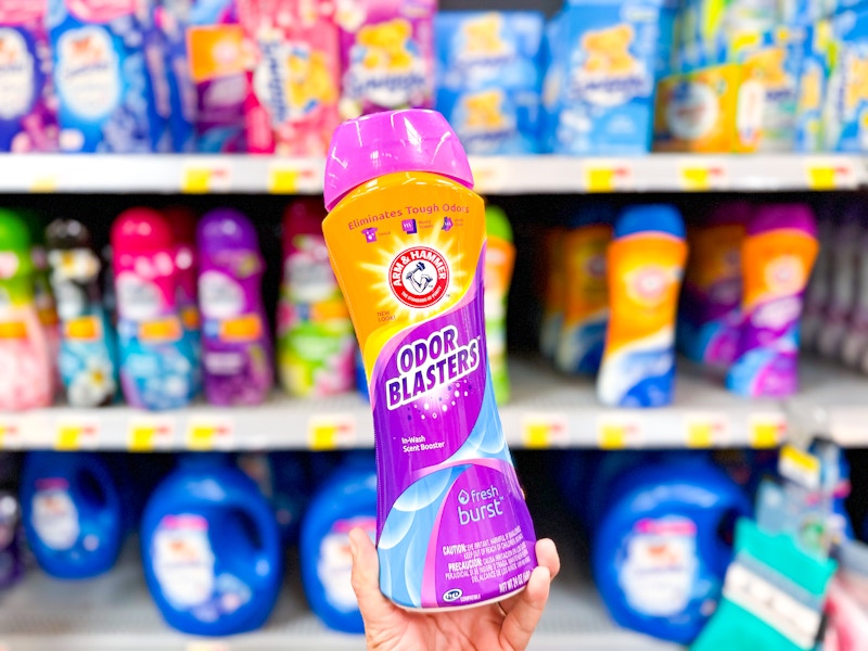 hand holding a bottle of arm and hammer scent beads in walmart laundry aisle