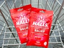 two bags of Halls cough drops in shopping cart