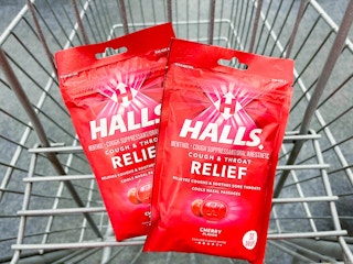 two bags of Halls cough drops in shopping cart