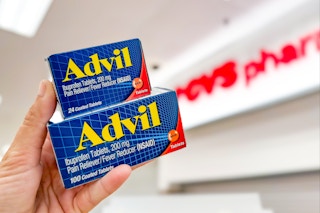 hand holding two advil products in front of cvs signage
