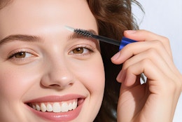 a person applying eyebrow serum