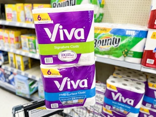 two packs of Viva Paper towels stack on topped of each other on edge of shopping cart