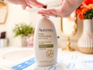 a person getting lotion from a pump lotion bottle