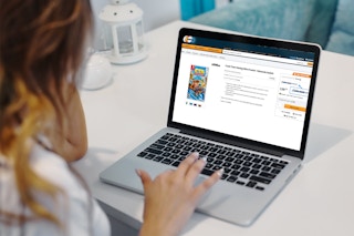 A person looking at Newegg on a laptop computer.
