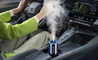 a car diffuser in a cup holder in a car