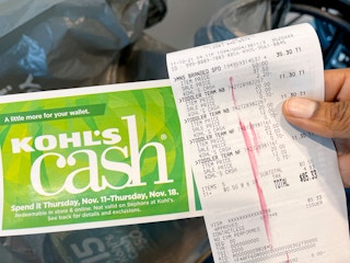 A person holding Kohl's cash and a receipt