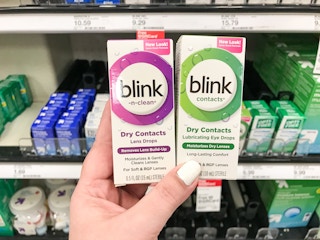 hand holding blink drops at target