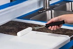 Lifestyle image of the Rust-Oleum Countertop Refinishing Kit being used in action (close up shot of paint roller in hand)