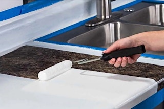 Lifestyle image of the Rust-Oleum Countertop Refinishing Kit being used in action (close up shot of paint roller in hand)