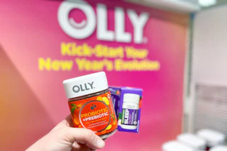 Two Olly Products held in front of Olly display poster in stores at Target