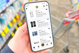 hand holding a smartphone displaying 1-clip coupons in the kcl app