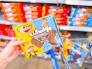 hand holding keebler el fudge cookies on walmart cart