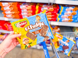 hand holding keebler el fudge cookies on walmart cart