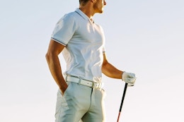 man wearing polo shirt at golf course