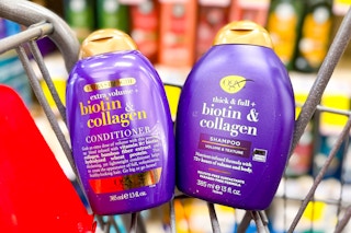 two bottles of ogx shampoo and conditioner in a cvs shopping cart