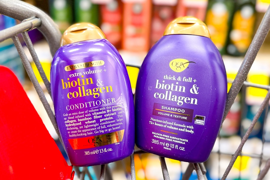 two bottles of ogx shampoo and conditioner in a cvs shopping cart