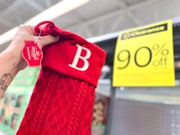 hand holding christmas stocking in walmart aisle