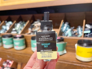 hand holding up a radiant sky wallflower refill at bath and body works
