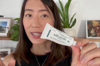 a woman holding simply neosporin