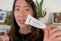 a woman holding simply neosporin