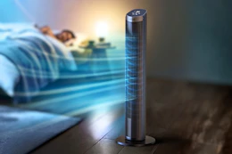 Lifestyle image of a 40-inch tower fan being used in a bedroom setting