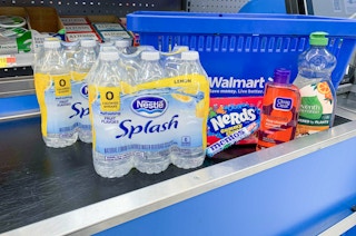 nestle splash nerds gummy clusters seventh generation dish soap mentos and clean and clear on a conveyor belt in front of a walmart basket