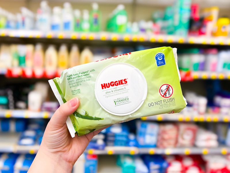 person holding a pack of huggies baby wipes