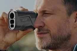 man looking through acer golf rangefinder