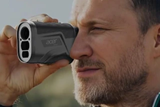 man looking through acer golf rangefinder