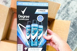 three cans of deodorant spray