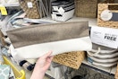 hand holding a canvas bin at dollar general