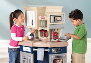 children playing with the tan and blue Little Tikes play kitchen