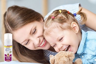 A mother and child play. A bottle of Little Remedies Nasal Mist is visible next to them