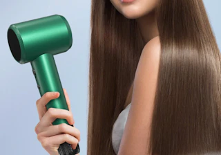 a person holding a green hair dryer