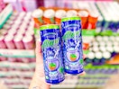 person holding 2 alani witch's brew energy drinks