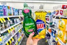 person holding palmolive and ajax dish soap in an aisle