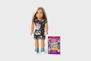 an american girl doll next to a book