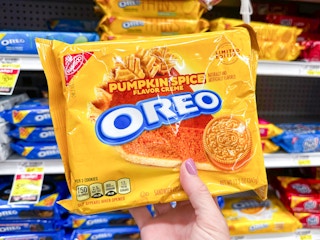 someone holding a package of pumpkin spice Oreo cookies