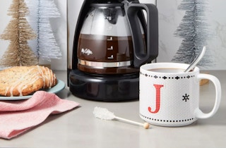 a monogram mug on a table by a coffee maker