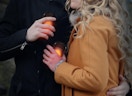 a woman and man holding hand warmers