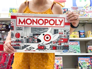 woman holding monopoly target edition game