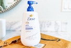 Dove body wash with pump  on top of Prime bag in bathroom