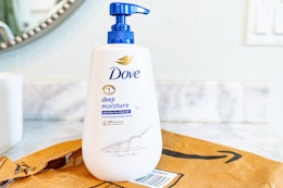 Dove body wash with pump  on top of Prime bag in bathroom