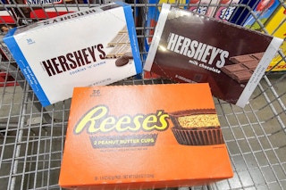 boxes of hersheys and reeses candy bars in a cart