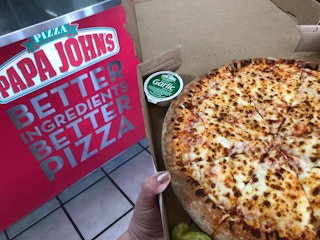 A Papa John's pizza in store.