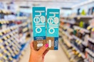 person holding 2 hello toothpastes in an aisle