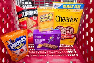 popcorners, granola bars, cheerios, scrub daddy, and nerds gummy clusters in a cart